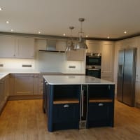 Fitted kitchen with hardwood flooring and doors.