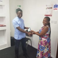 Jafeth Leonard being awarded employee of month from Abigail.