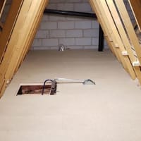 Loft hatch with ladder, insulation, boarding, shelving and lighting.